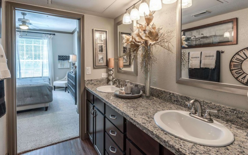 bathroom with a large mirror and dual sinks