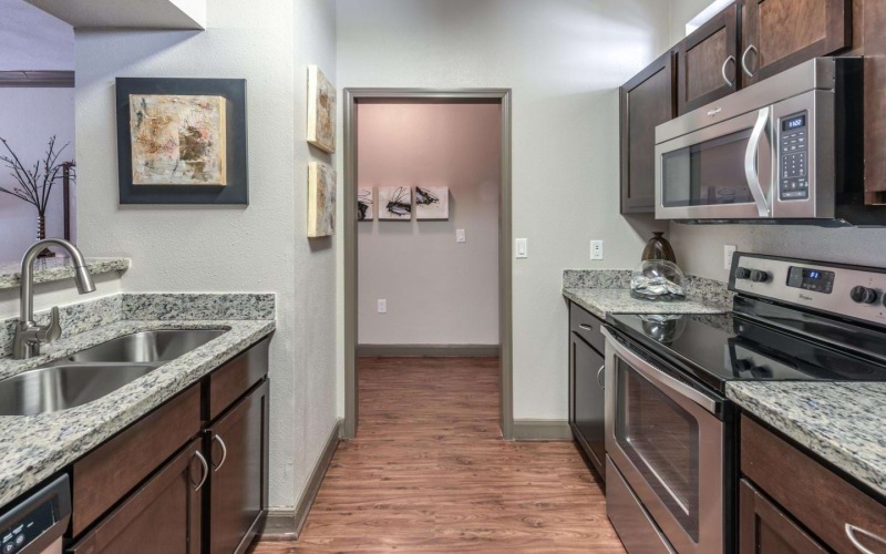Bright galley kitchen at Deerwood Apartments, one of our apartments in Houston with a balcony.