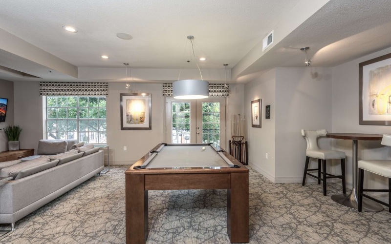 game room with billiards table and tvs